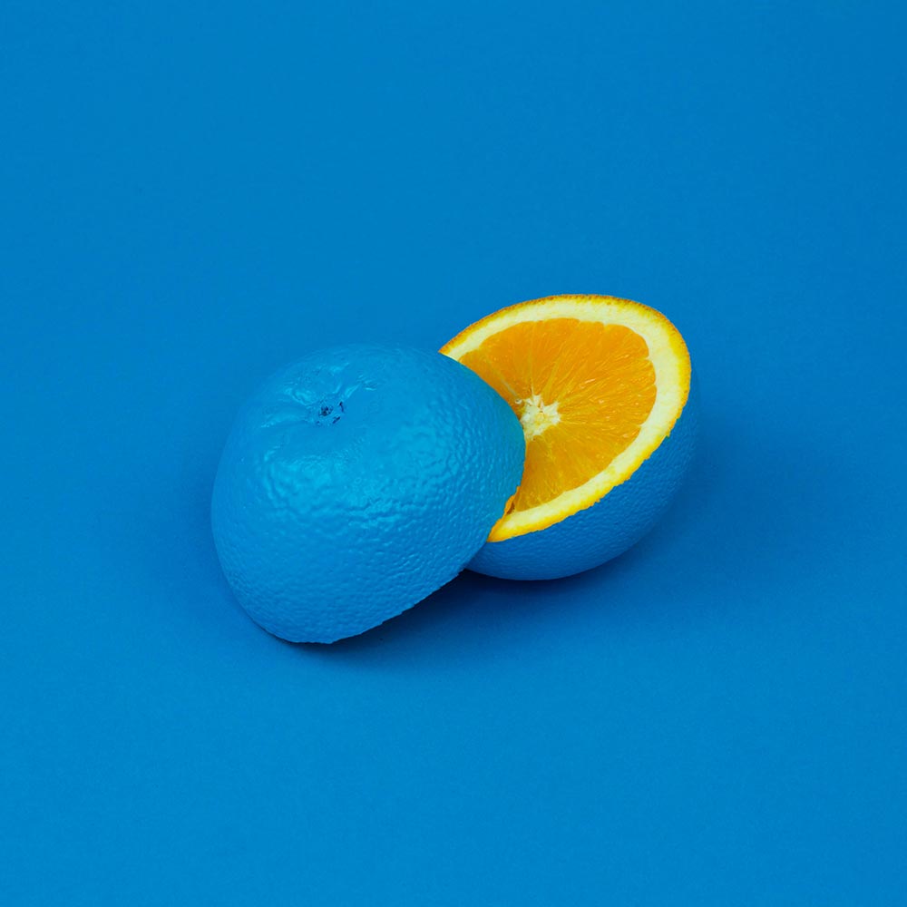 blue coloured sliced orange on blue background