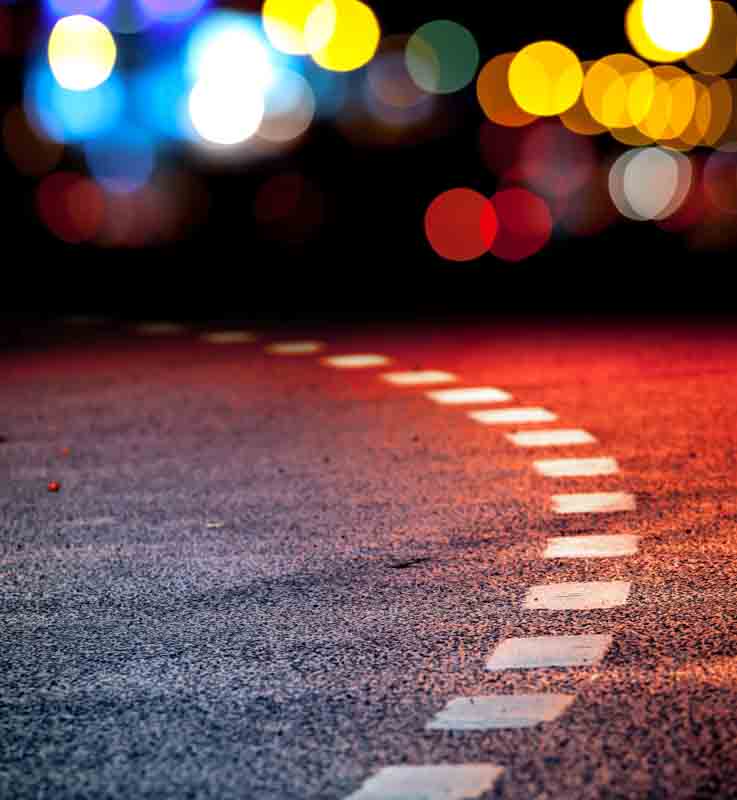 white road markings on street at night